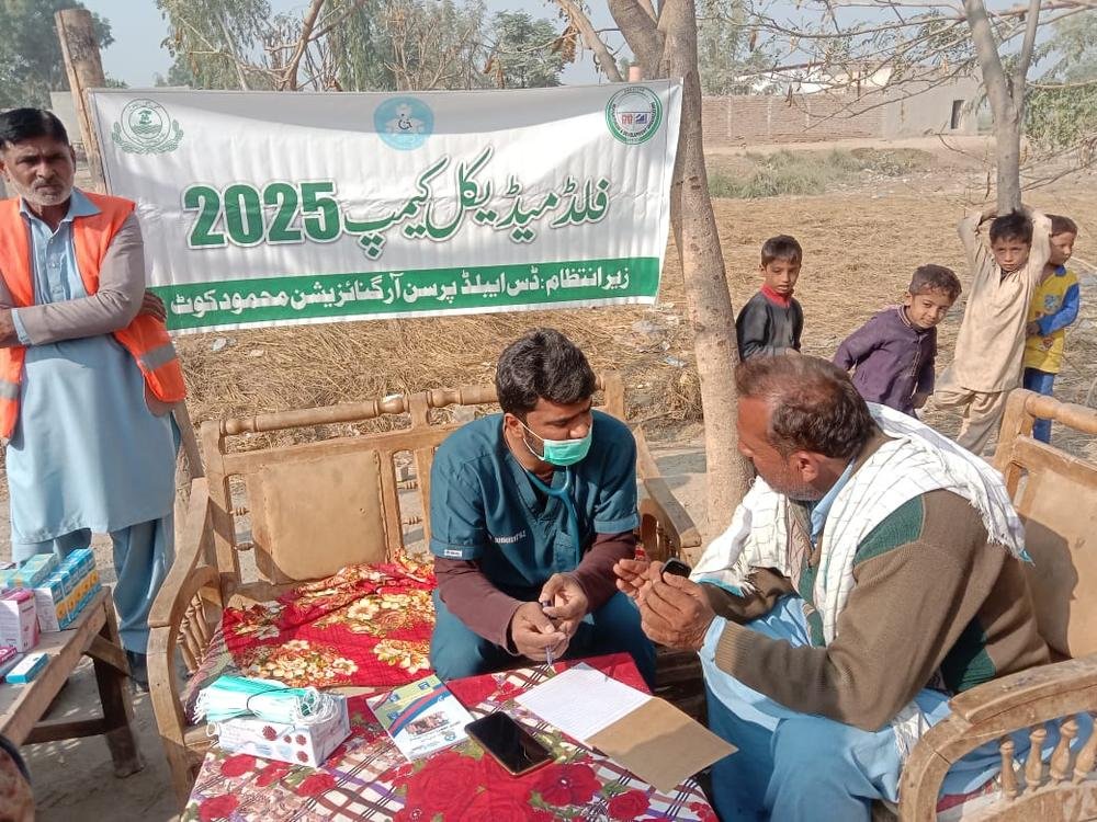 DPO doctor treating a patient at a free medical camp